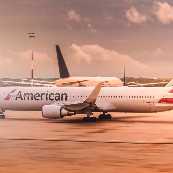 white american airplane parked on airport