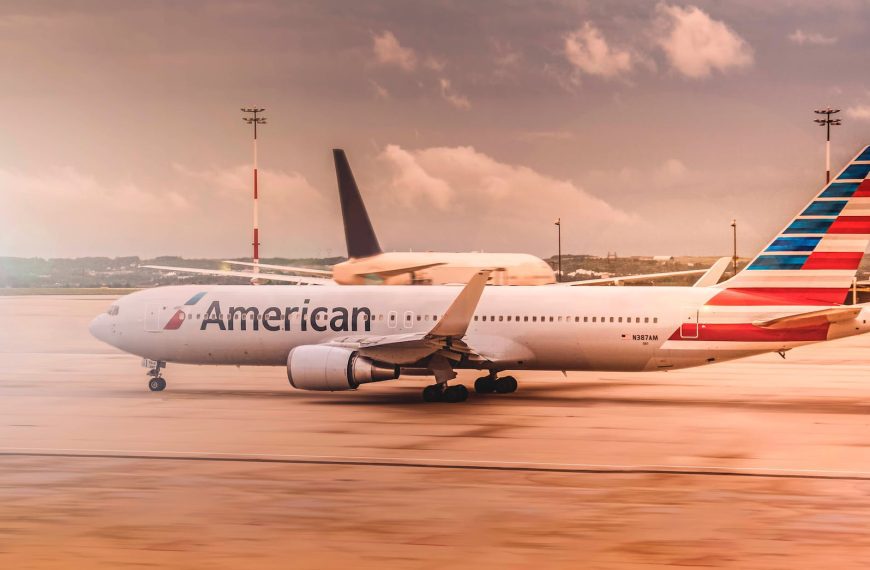 white american airplane parked on airport