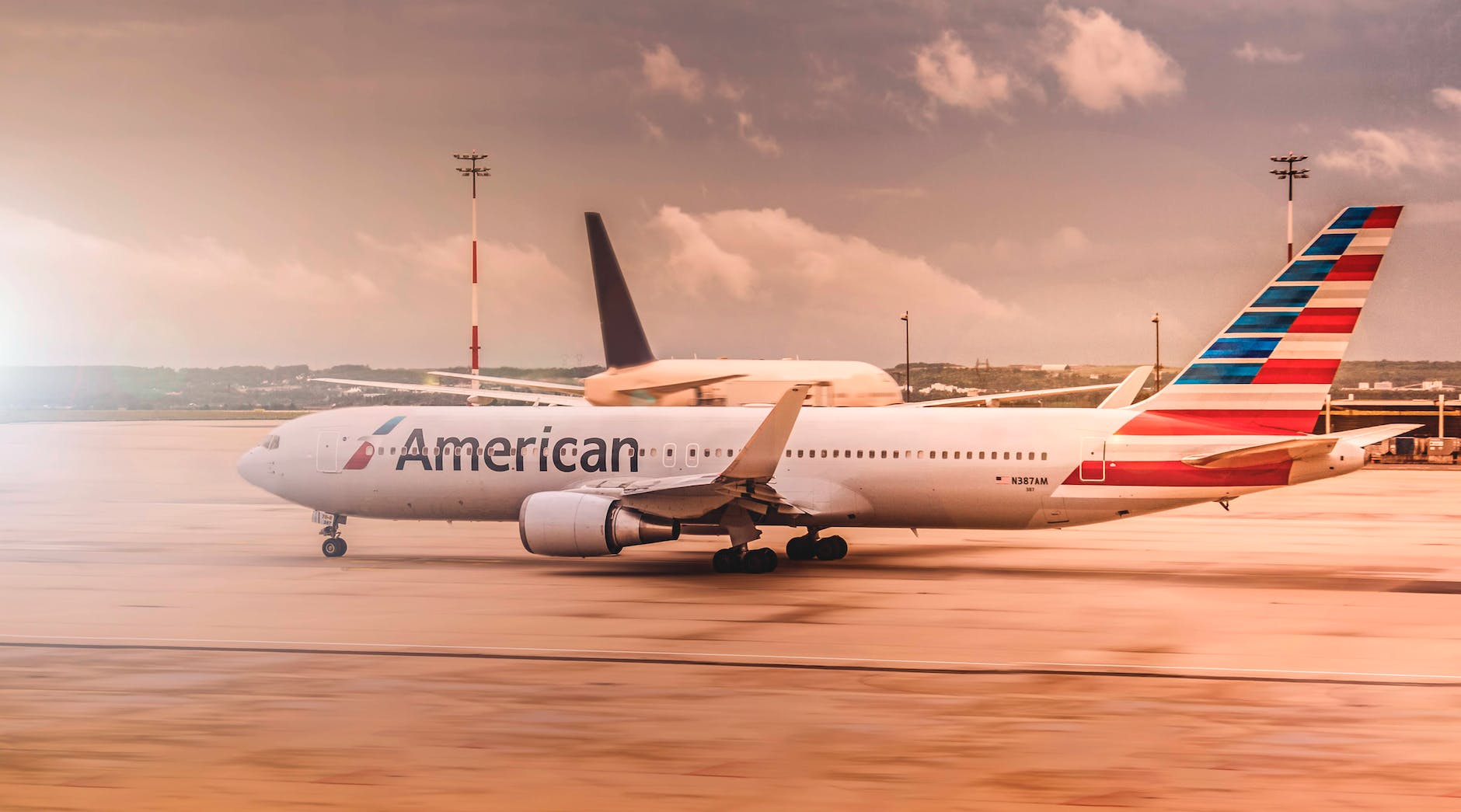 white american airplane parked on airport